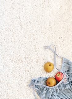 Three Apples on White Rug